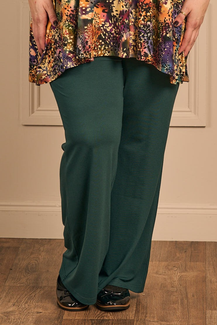 OUr model is wearing Exelle Buto jersey trousers in forest green for Froxx Clothing plus sizes