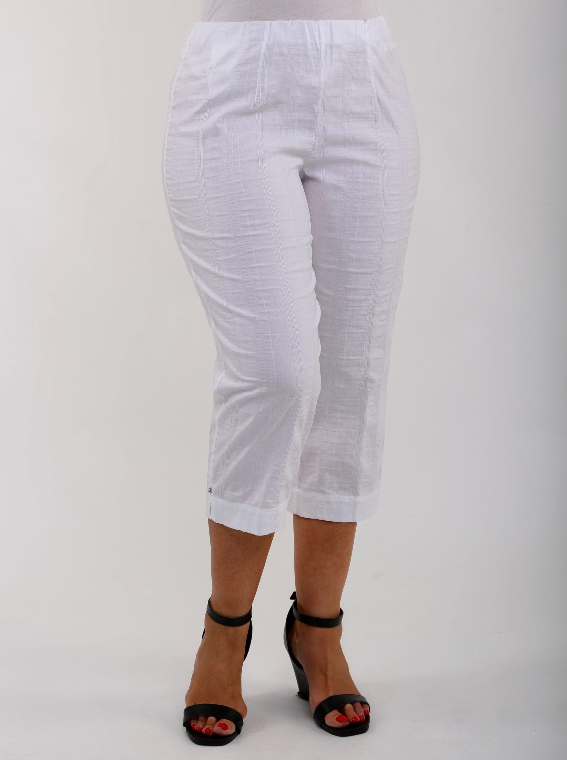 Woman wearing white KJ Brand Wash & Go pedal pushers