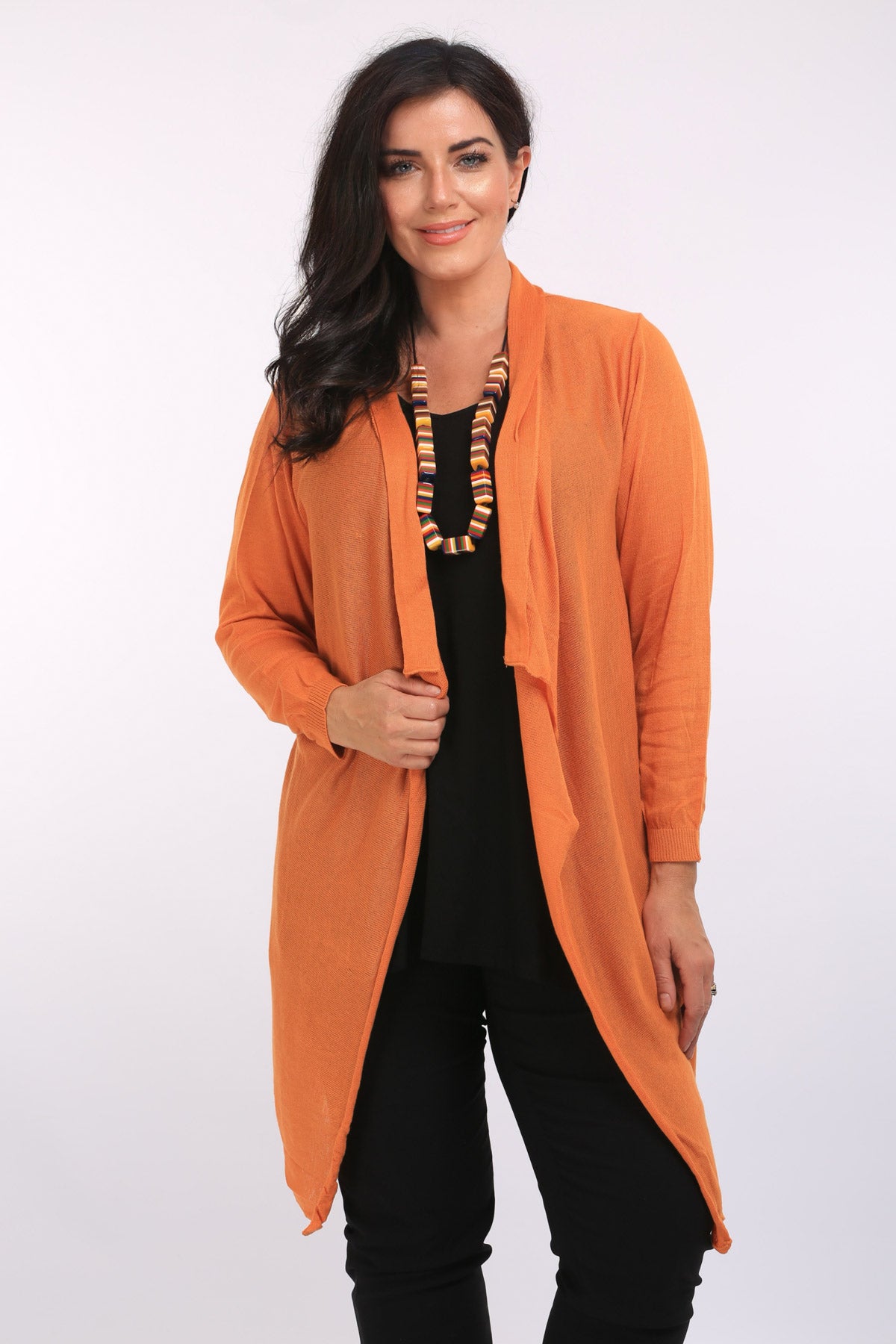 Woman is wearing Orientique 100% cotton waterfall cardi in paprika