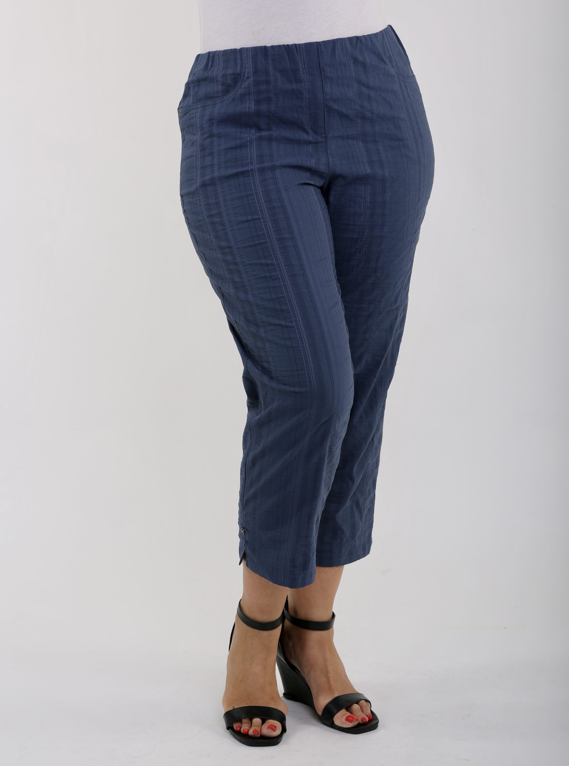 Woman wearing KJ Brand Wash & Go stretch pedal pushers in Denim
