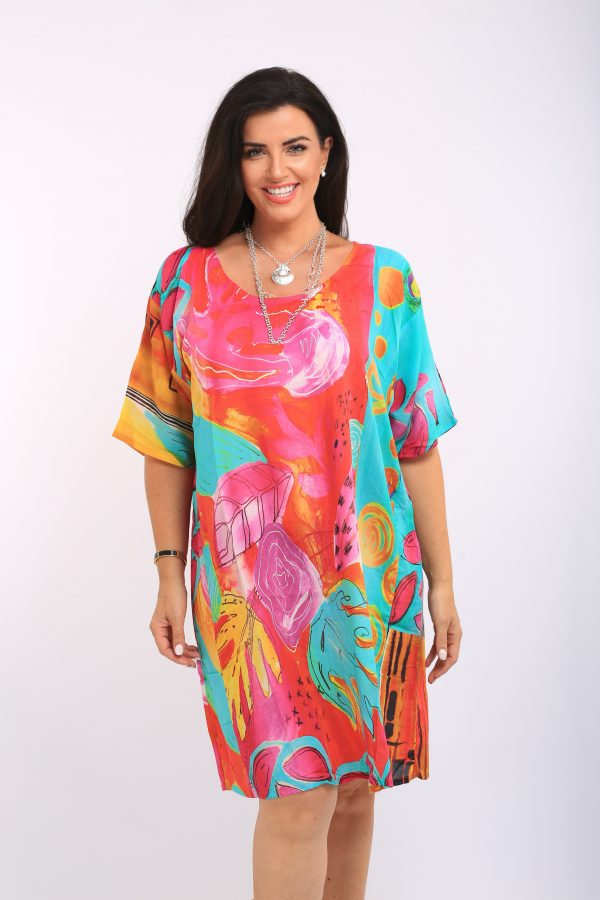 Woman is wearing Orientique digital print loose fit tunic dress in citrus and pink