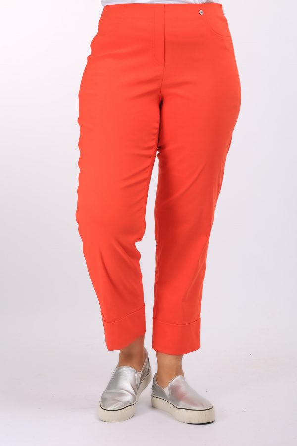 Woman is wearing Robell Bella stretch crops with cuff detail in orange