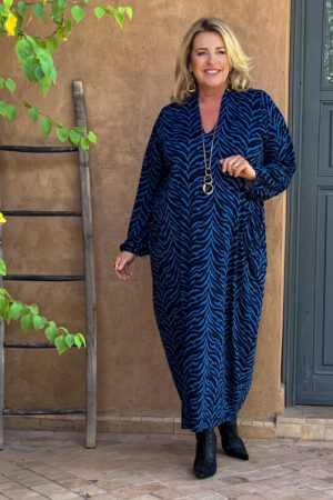 Model is wearing Kasbah Romana silky jersey bubble dress in stormy blue for Froxx CLothing plus sizes