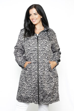 Our model is wearing Frandsen animal print water repellent jacket in taupe and black for Froxx Clothing plus sizes