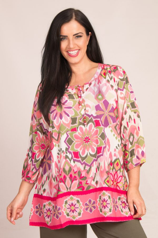 Our model is wearing Via Appia retro floral tunic in watermelon for Froxx Clothing plus sizes